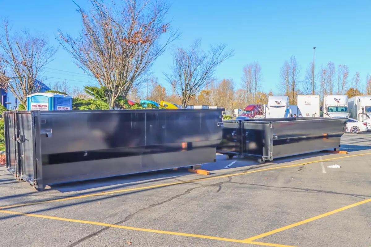 Professional dumpster rental service with roll-off container on residential driveway in Jefferson Hills